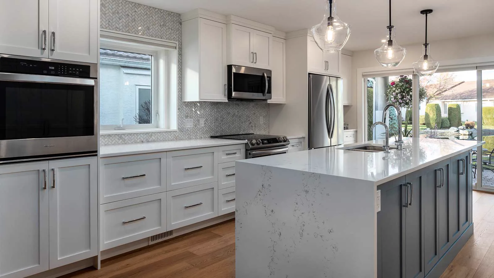 Bright custom kitchen renovation with a large island by Amend Developments