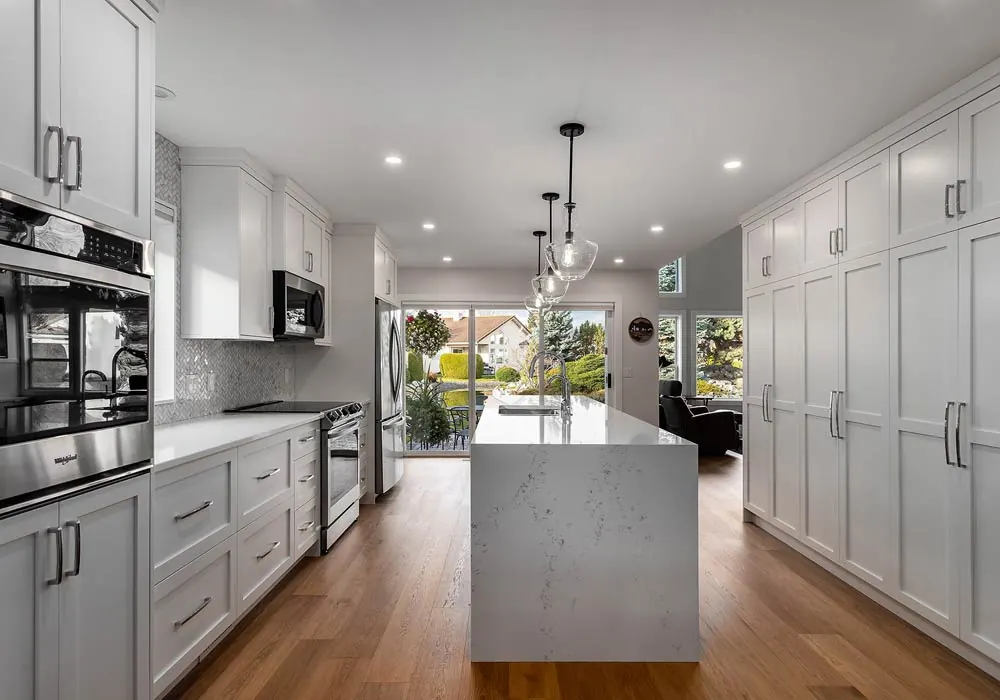 Bright custom kitchen and living room renovation by Amend Developments